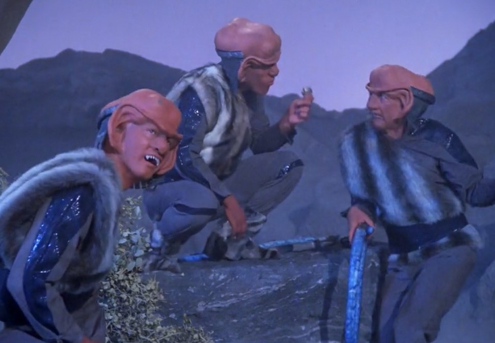 Still frame from Star Trek: The Next Generation Season 1 showing three Ferengi.
