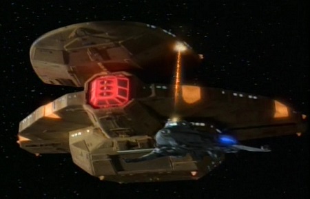 Still frame from Star Trek: Voyager showing a Cardassian ship firing on a much smaller Maquis vessel.