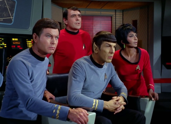 Still frame from Star Trek: The Original Series showing McCoy, Scotty, Spock, and Uhura.