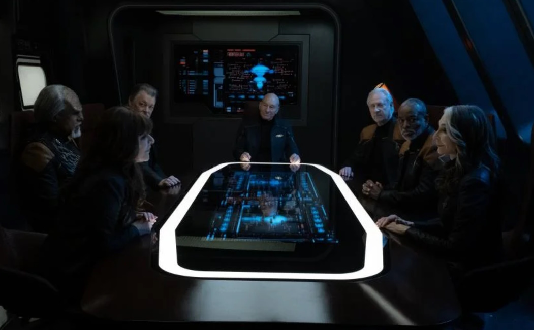 Still frame from Star Trek: Picard Season 2 (2022) showing the main characters around the conference table.