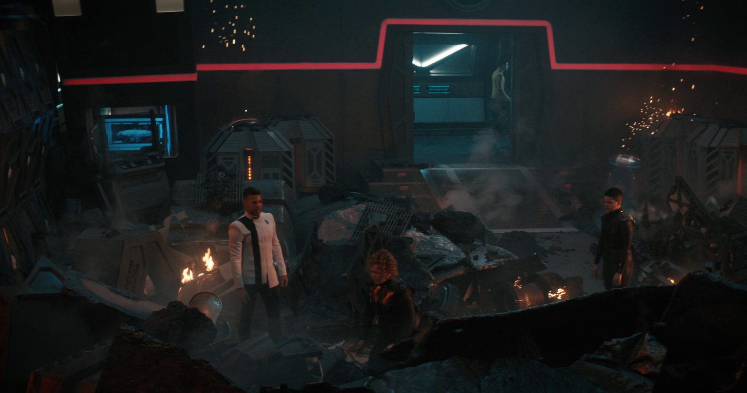 Still frame from Star Trek: Discovery 4x01 Kobayashi Maru, showing characters amidst rubble and debris.