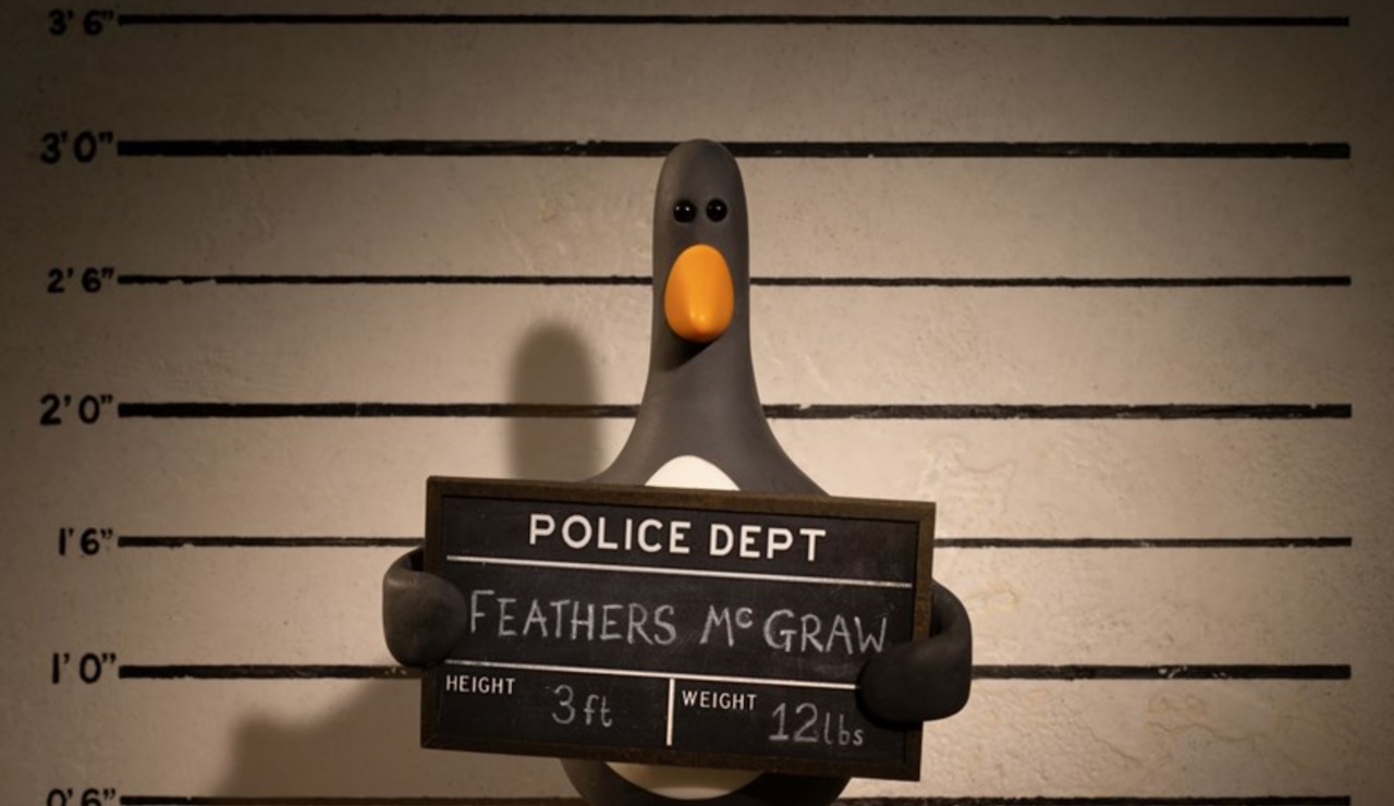 Promo image for Wallace and Gromit: Vengeance Most Fowl showing Feathers McGraw's mug shot.