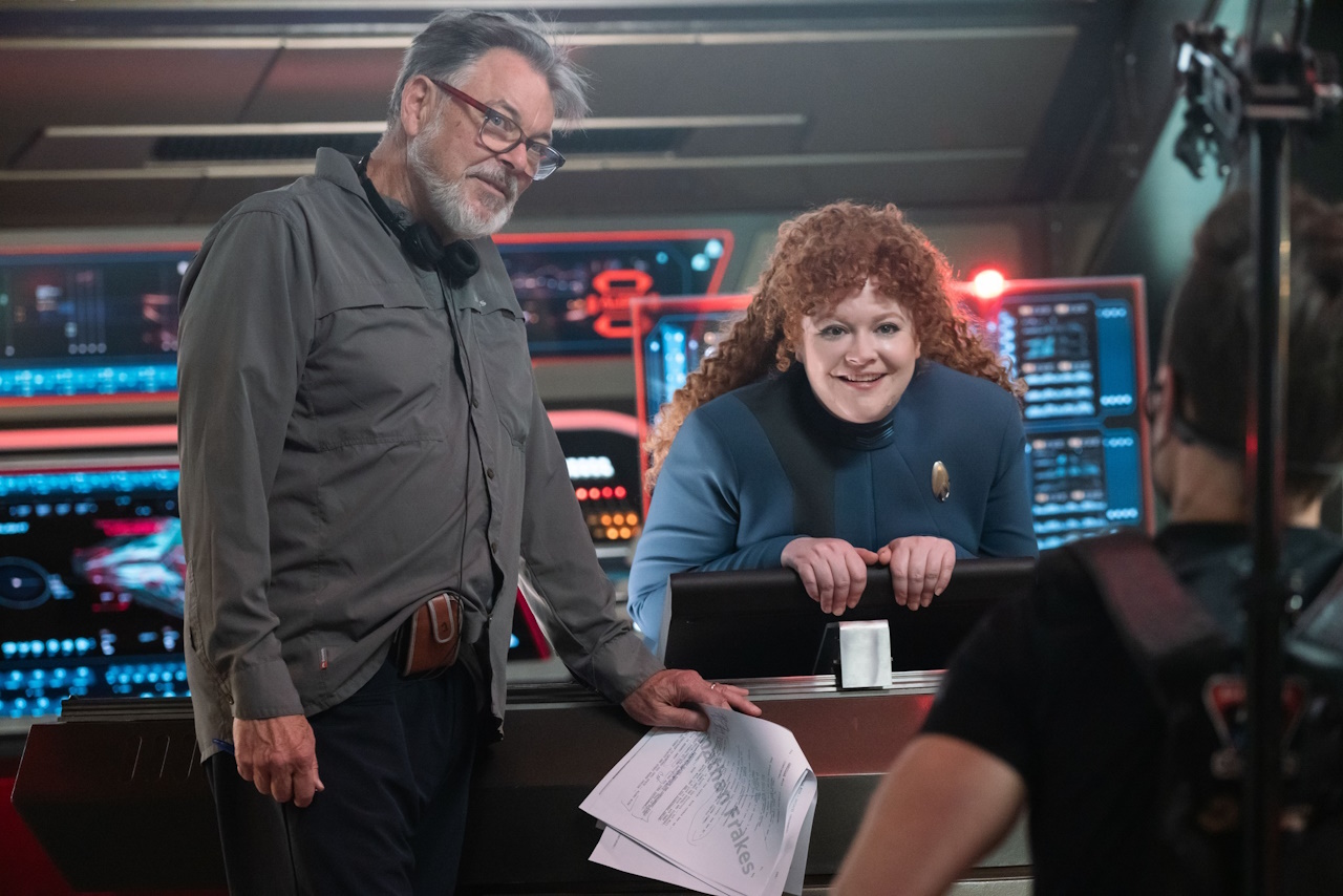 Behind-the-scenes photo showing Jonathan Frakes and Mary Wiseman.