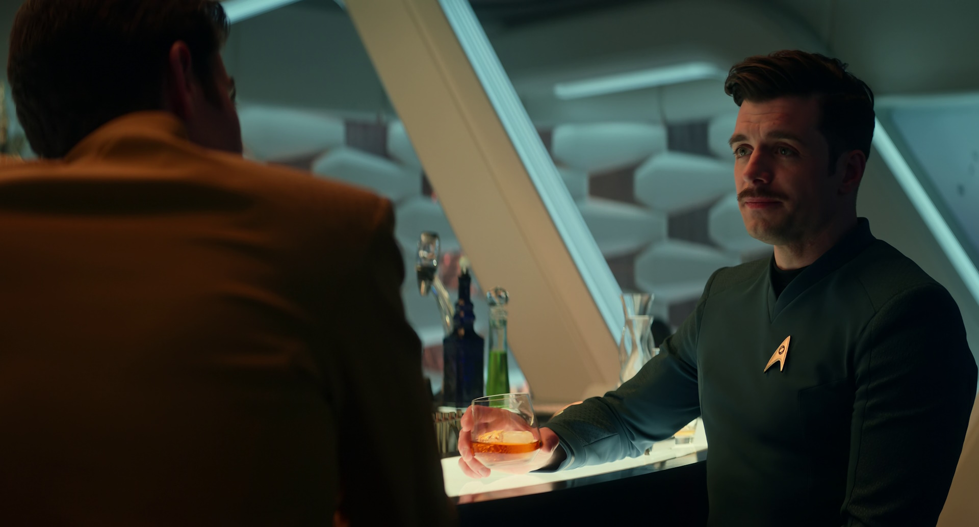 Still frame from Star Trek: Strange New Worlds Season 2 (2023) showing Jim and Sam Kirk at the bar.