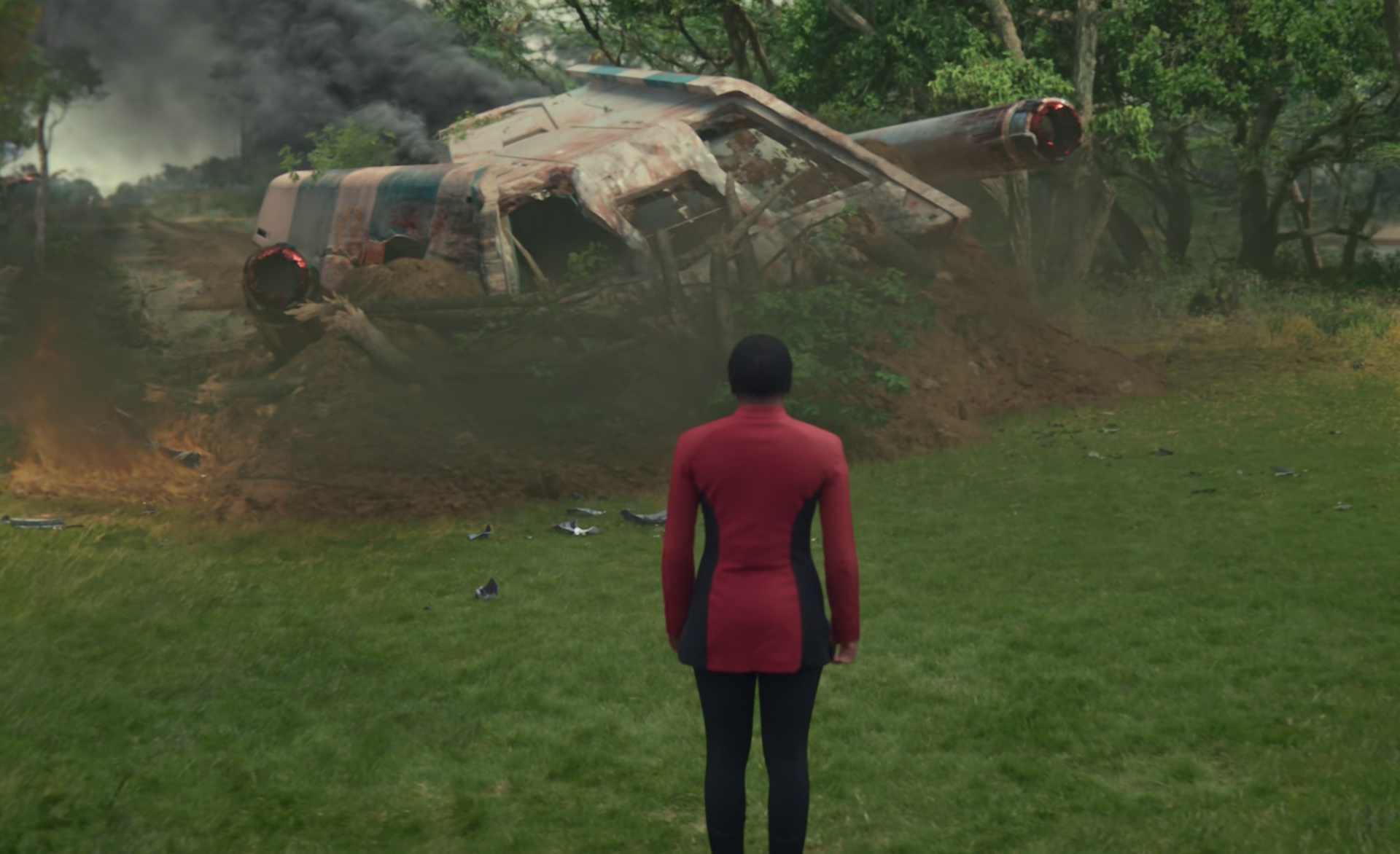 Still frame from Star Trek: Strange New Worlds Season 2 (2023) showing Uhura by a crashed shuttle.