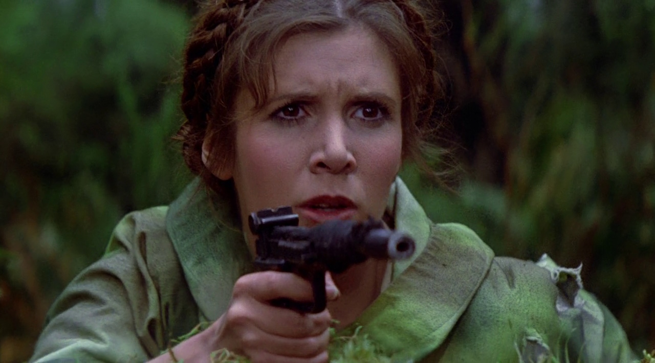 Still frame from Return of the Jedi (1983) showing Princess Leia holding a blaster.