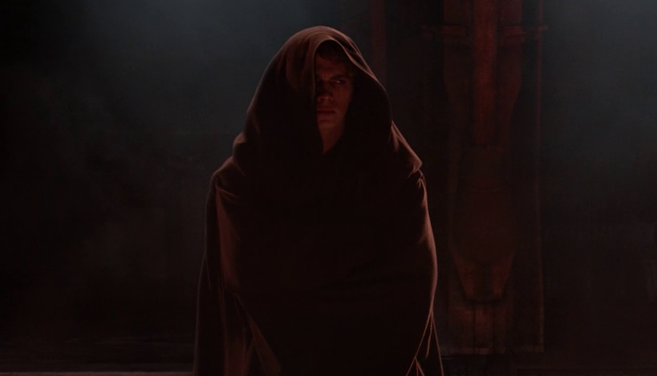 Still frame from Revenge of the Sith (2005) showing Anakin Skywalker in a hooded robe.