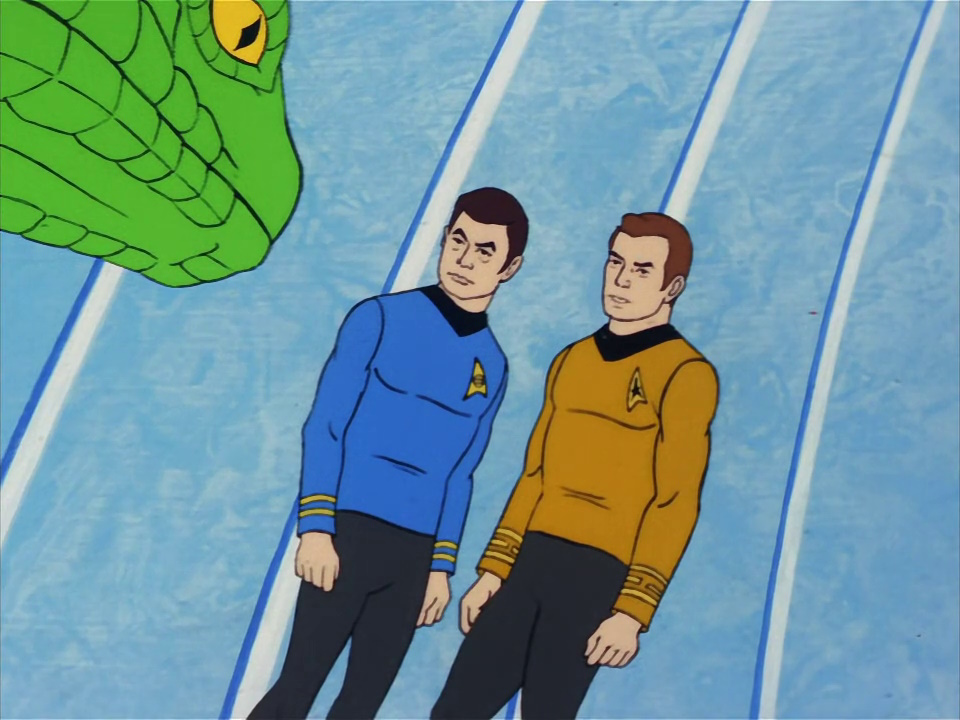 Still frame from Star Trek: The Animated Series Season 2 (1974) showing Kirk and Dr McCoy with an alien.