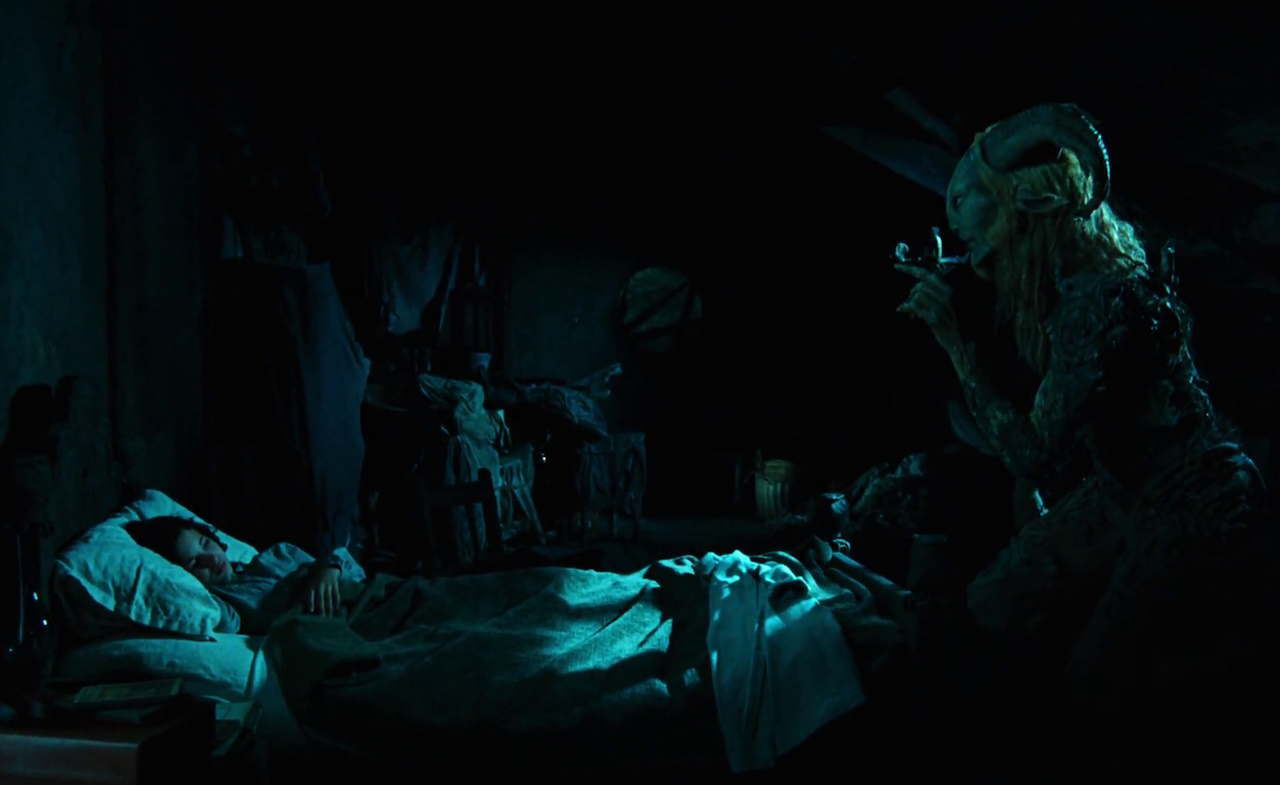 Still frame from Pan's Labyrinth (2006) showing Ofelia in bed and the Faun.
