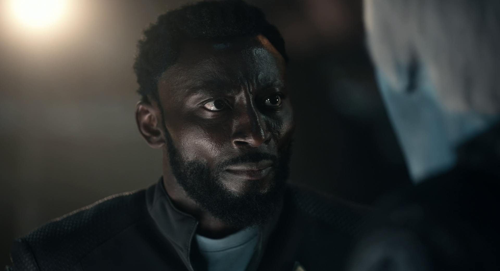 Still frame from Star Trek: Strange New Worlds Season 2 (2023) showing a flashback of Dr M'Benga.