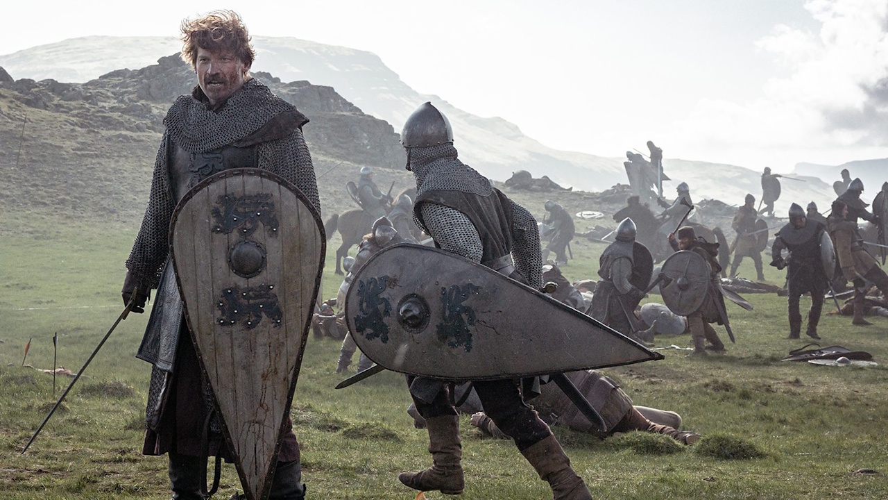 Promo photo for King and Conqueror showing William on a battlefield holding a large shield.