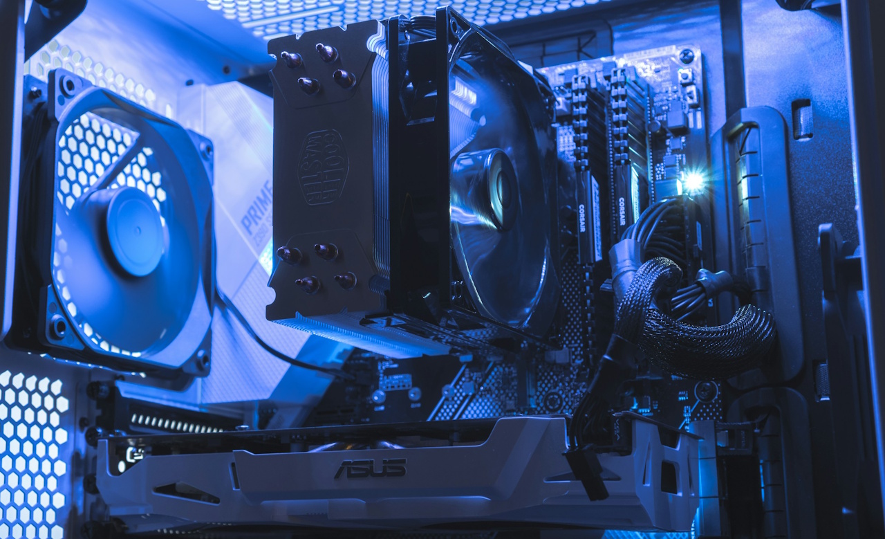 A stock photo of the inside of a gaming PC, with spinning fans, a graphics card, and a motherboard all visible.