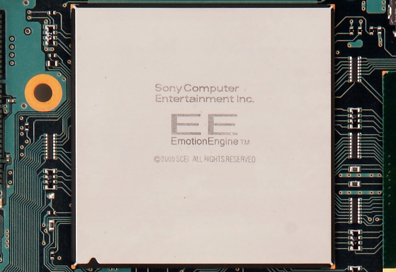 A PlayStation 2 Emotion Engine chip; a silver chip mounted to a green circuit board.