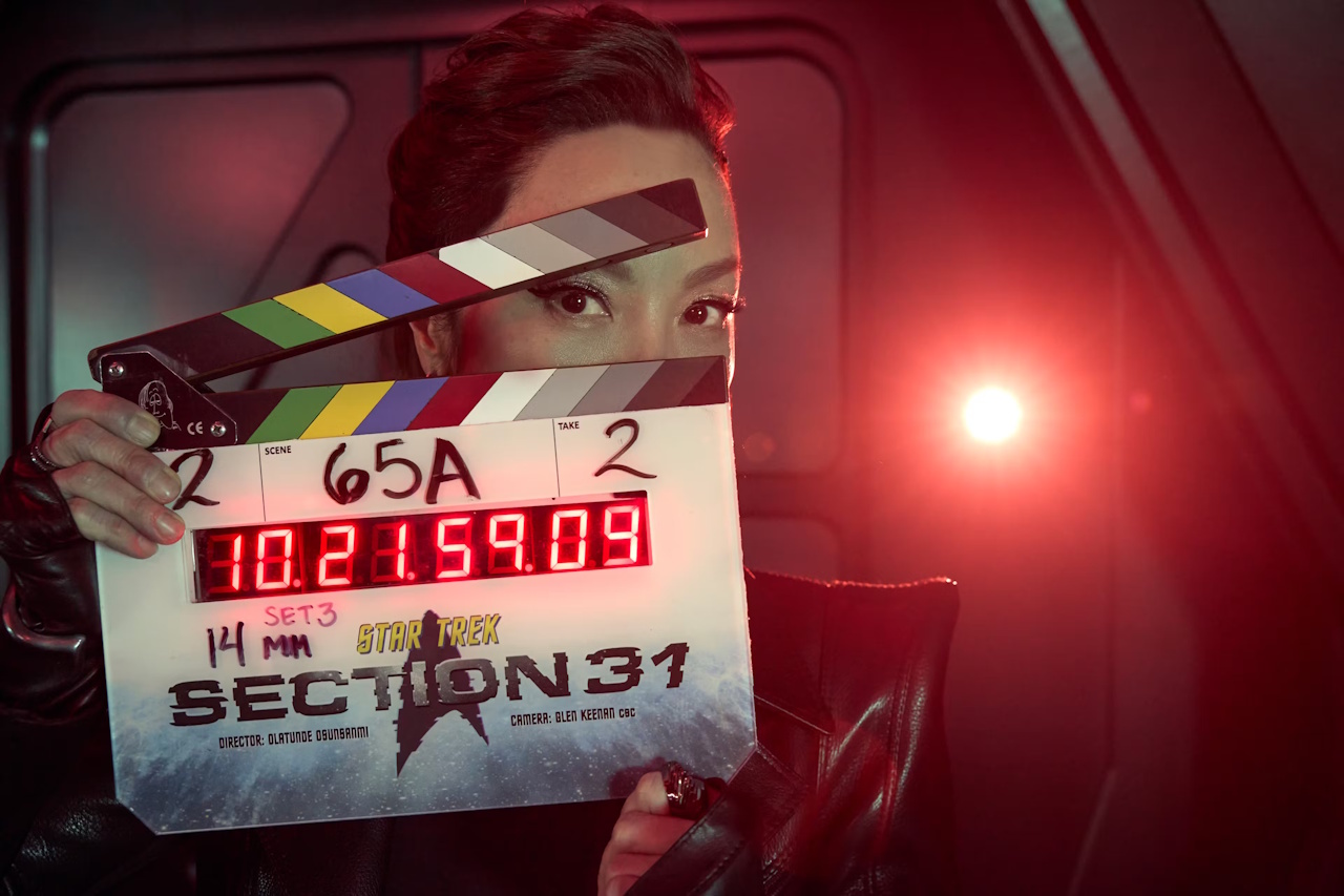 Behind-the-scenes photo from the set of Star Trek: Section 31, showing Michelle Yeoh holding a clap-board.