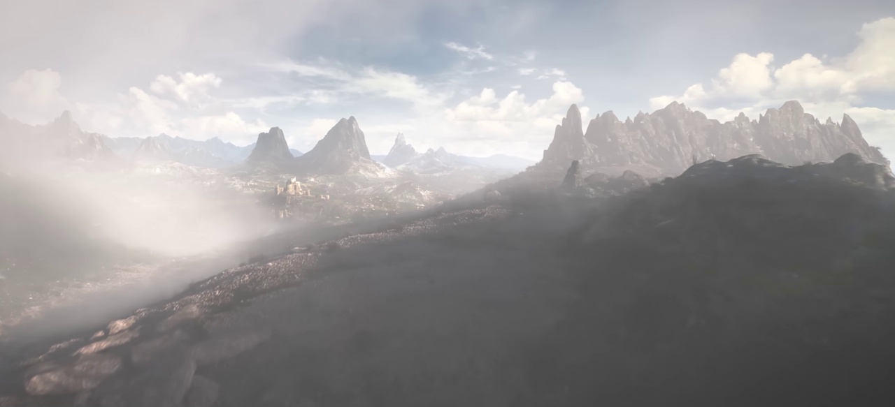 Still frame from the 2018 teaser trailer for The Elder Scrolls VI showing mountains in the mist.
