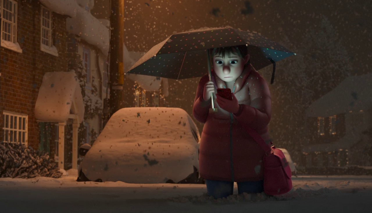 Still frame from That Christmas showing Mrs Williams looking at her phone in the snow.