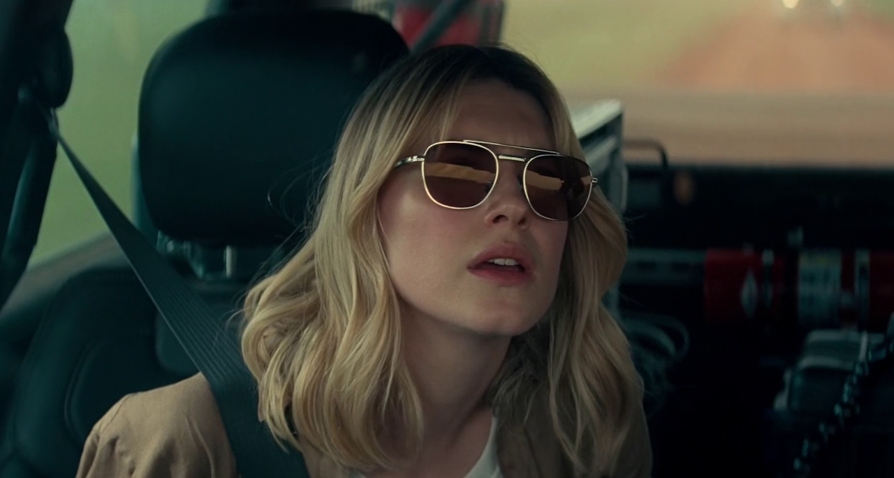 Still frame from Twisters showing a character in a car wearing sunglasses.