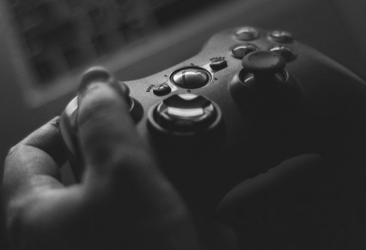Black-and-white photo of a person holding a video game controller.