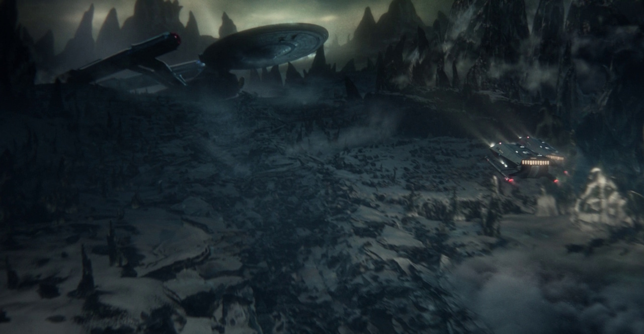 Still frame from Star Trek: Strange New Worlds showing two shuttlecraft approaching a wrecked starship.