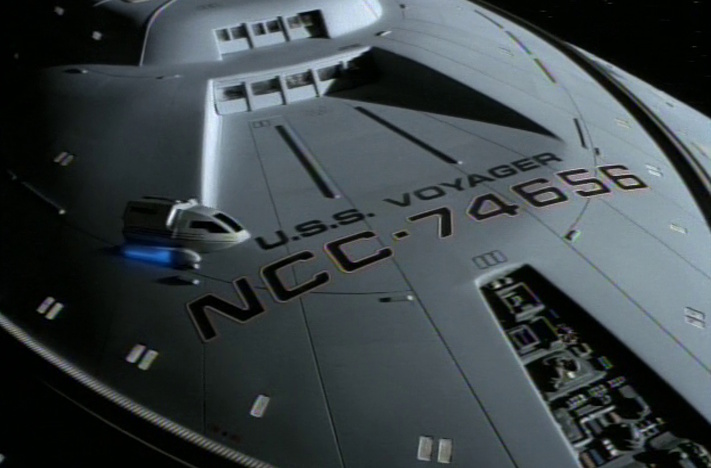 Still frame from Star Trek: Voyager showing a shuttlecraft flying over Voyager's saucer section.