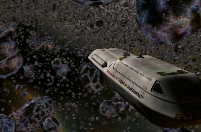 Still frame from Star Trek: Voyager showing an escape pod floating in a nebula.
