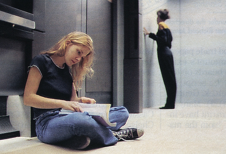 Behind-the-scenes photo from Star Trek: Voyager showing Jennifer Lien reading her script while sat on the floor.