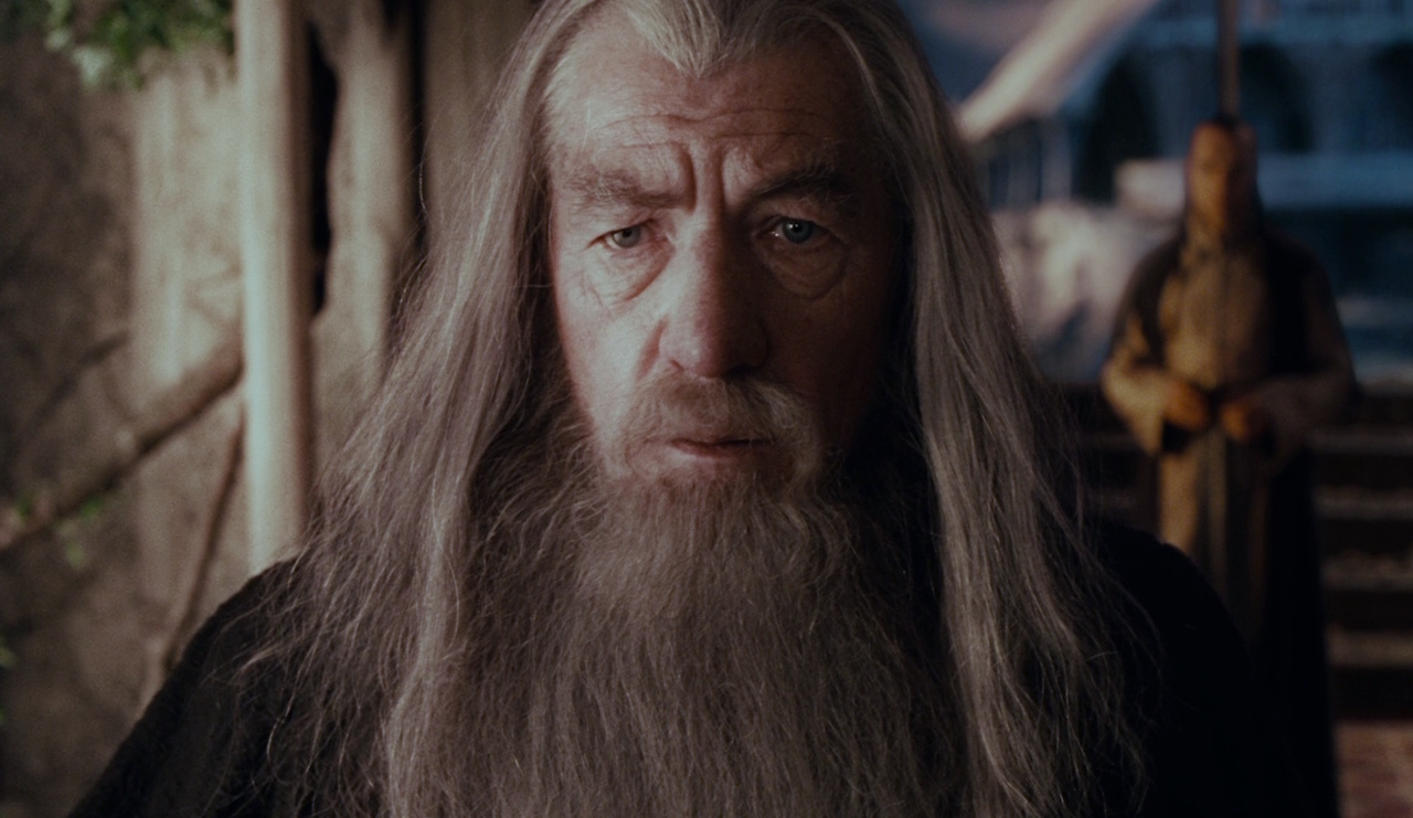 Still frame from The Lord of the Rings: The Fellowship of the Ring, showing Gandalf with Elrond in the background.