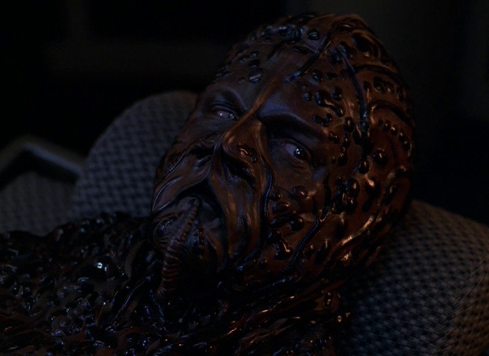 Still frame from Star Trek: Voyager showing an alien lying in sickbay.