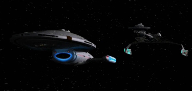 Still frame from Star Trek: Voyager showing the USS Voyager and a Klingon battle cruiser side by side.