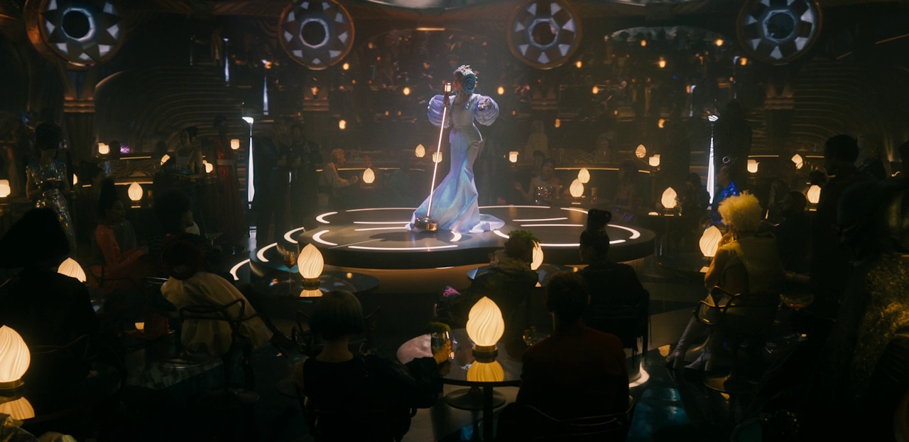 Still frame from Star Trek: Section 31 (2025) showing a singer at Georgiou's bar.