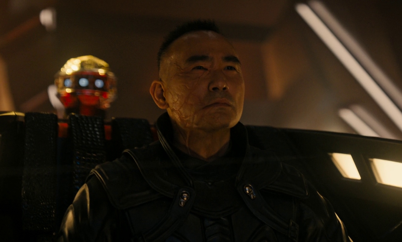 Still frame from Star Trek: Section 31 (2025) showing San in the captain's chair of his ship.