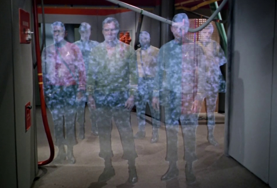 Still frame from Star Trek: The Original Series showing several characters materialising in a transporter beam.