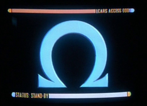 Still frame from Star Trek: Voyager showing the Omega mission symbol on an LCARS monitor.