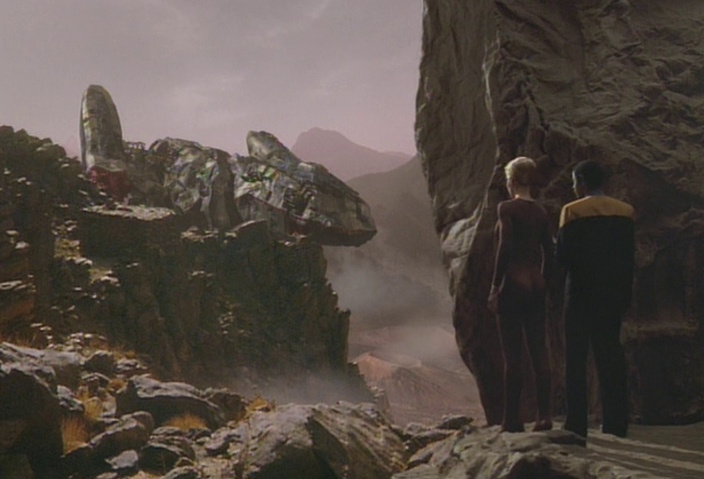 Still frame from Star Trek: Voyager showing Seven of Nine and Tuvok surveying a crashed starship.