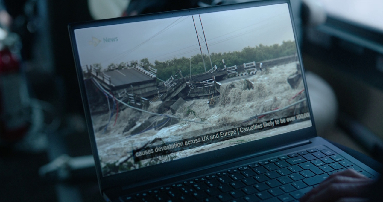 Still frame from The Rig Season 2 (2025) showing a news report about the tsunami on a laptop screen.