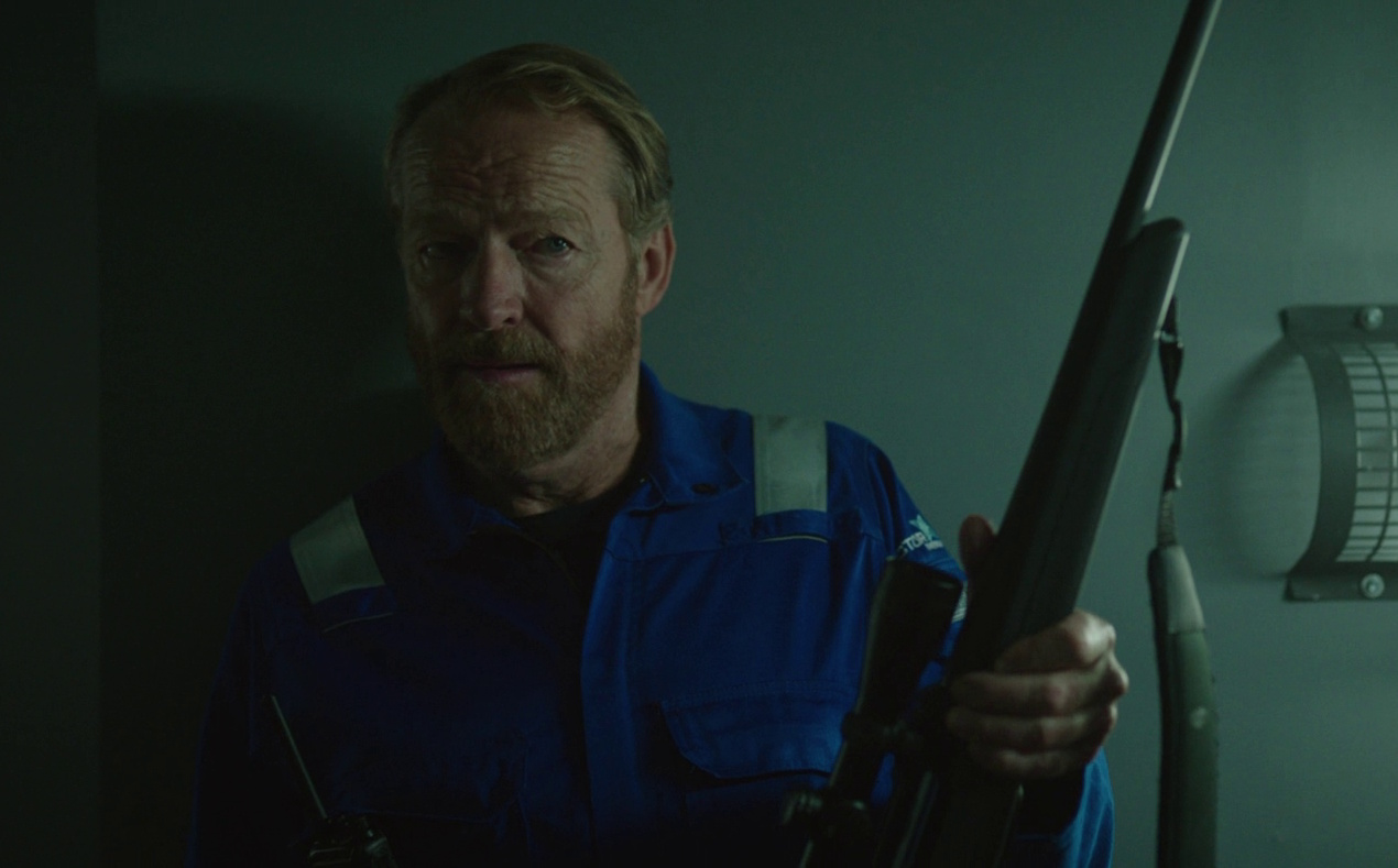 Still frame from The Rig Season 2 (2025) showing Magnus holding a rifle.