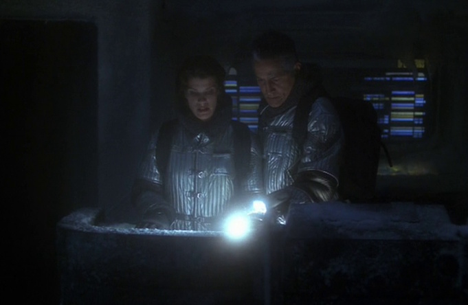 Still frame from Star Trek: Voyager showing Tessa and an older Chakotay aboard the frozen, derelict Voyager.