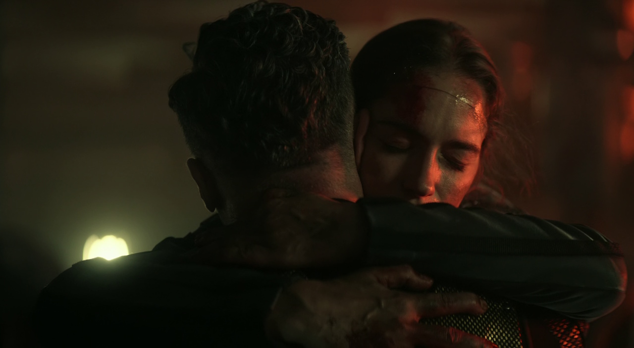 Still frame from Star Trek: Strange New Worlds Season 2 Episode 10 (2023) showing Captain Batel hugging Captain Pike.