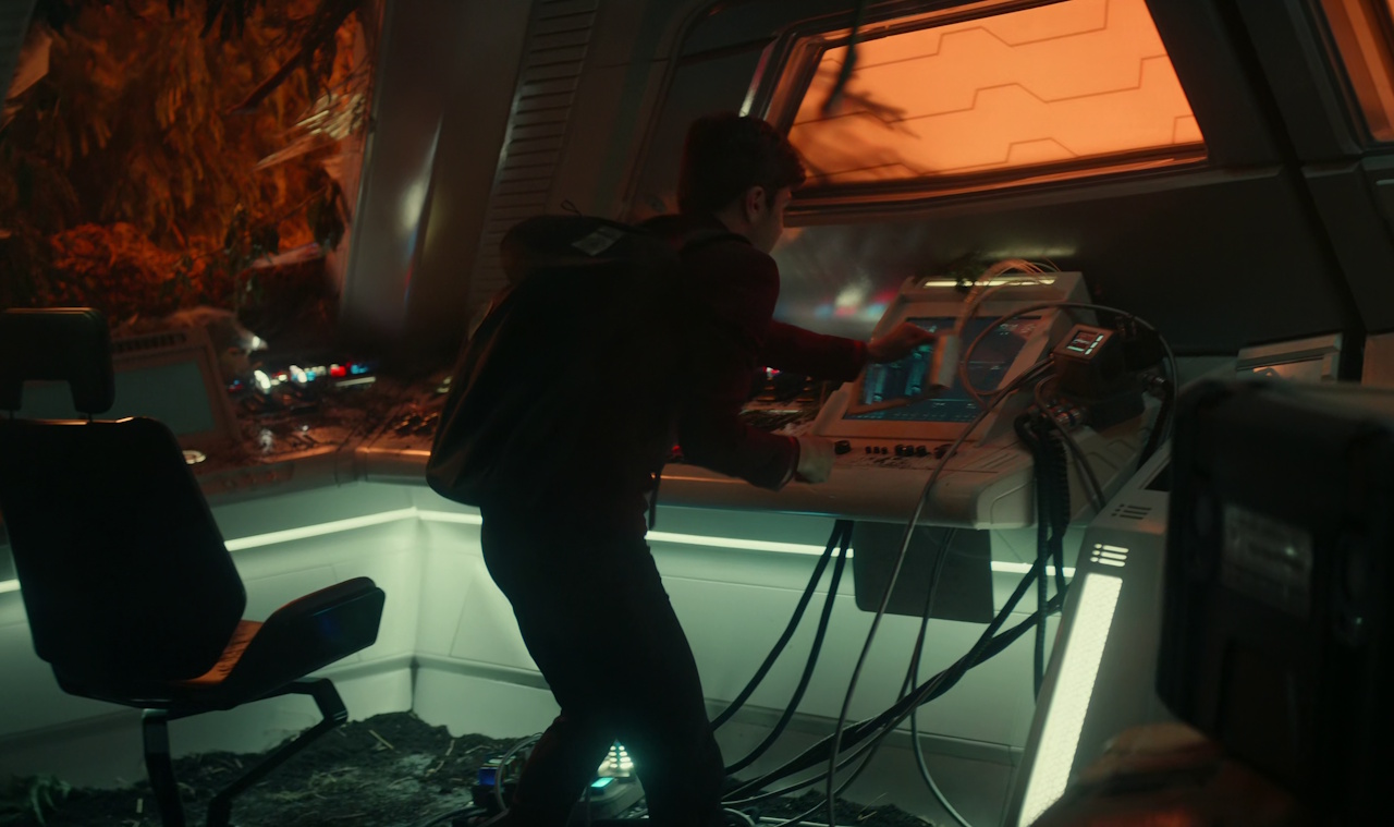 Still frame from Star Trek: Strange New Worlds Season 2 Episode 10 (2023) showing Scotty with his transponder device.