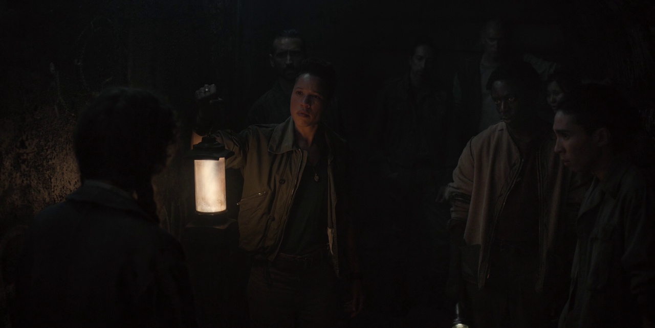 Still frame from Silo Season 2 (2024-25) showing Walker, Shirley, and other conspirators in the Down Deep.