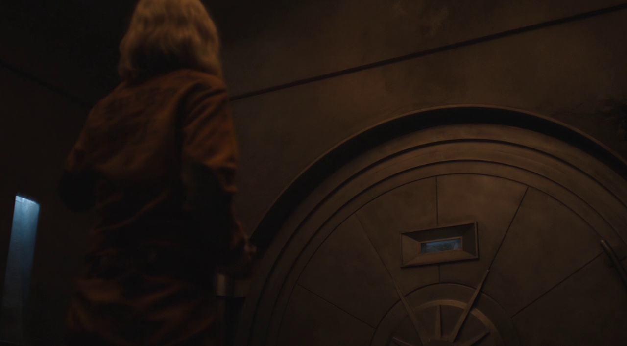 Still frame from Silo Season 2 (2024-25) showing Juliette talking to Solo through the vault door.