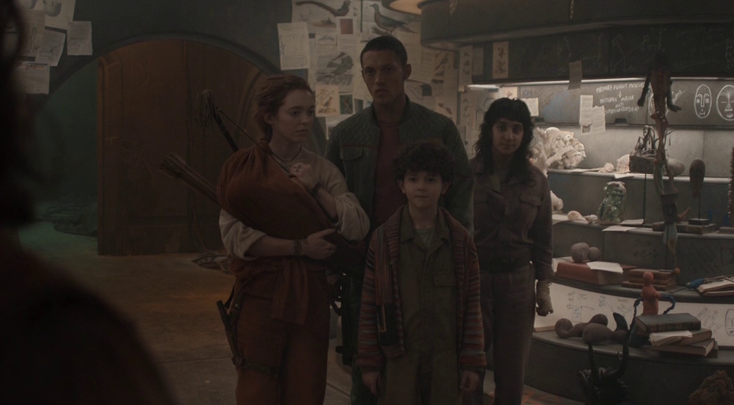 Still frame from Silo Season 2 (2024-25) showing Audrey, Rick, Eater/Hope, and their baby.