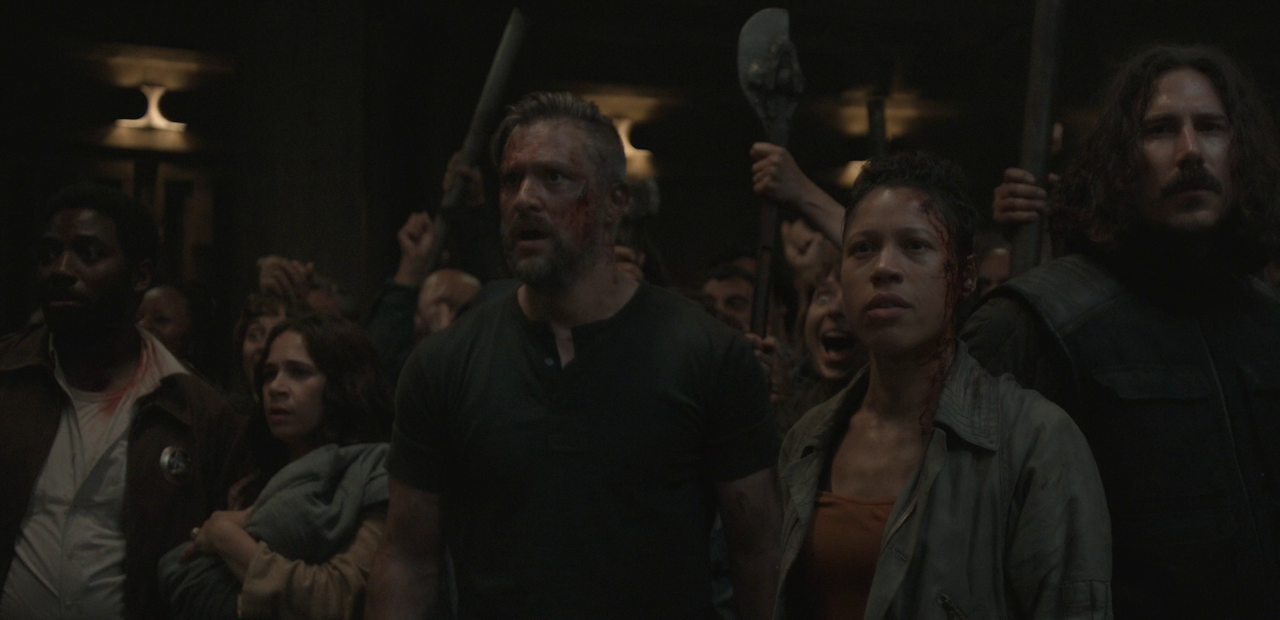 Still frame from Silo Season 2 (2024-25) showing a crowd of rebels.