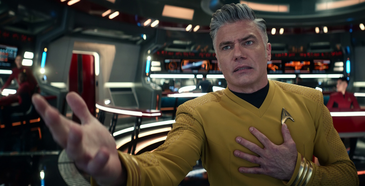 Still frame from Star Trek: Strange New Worlds Season 2 (2023) showing Captain Pike with his hand outstretched.