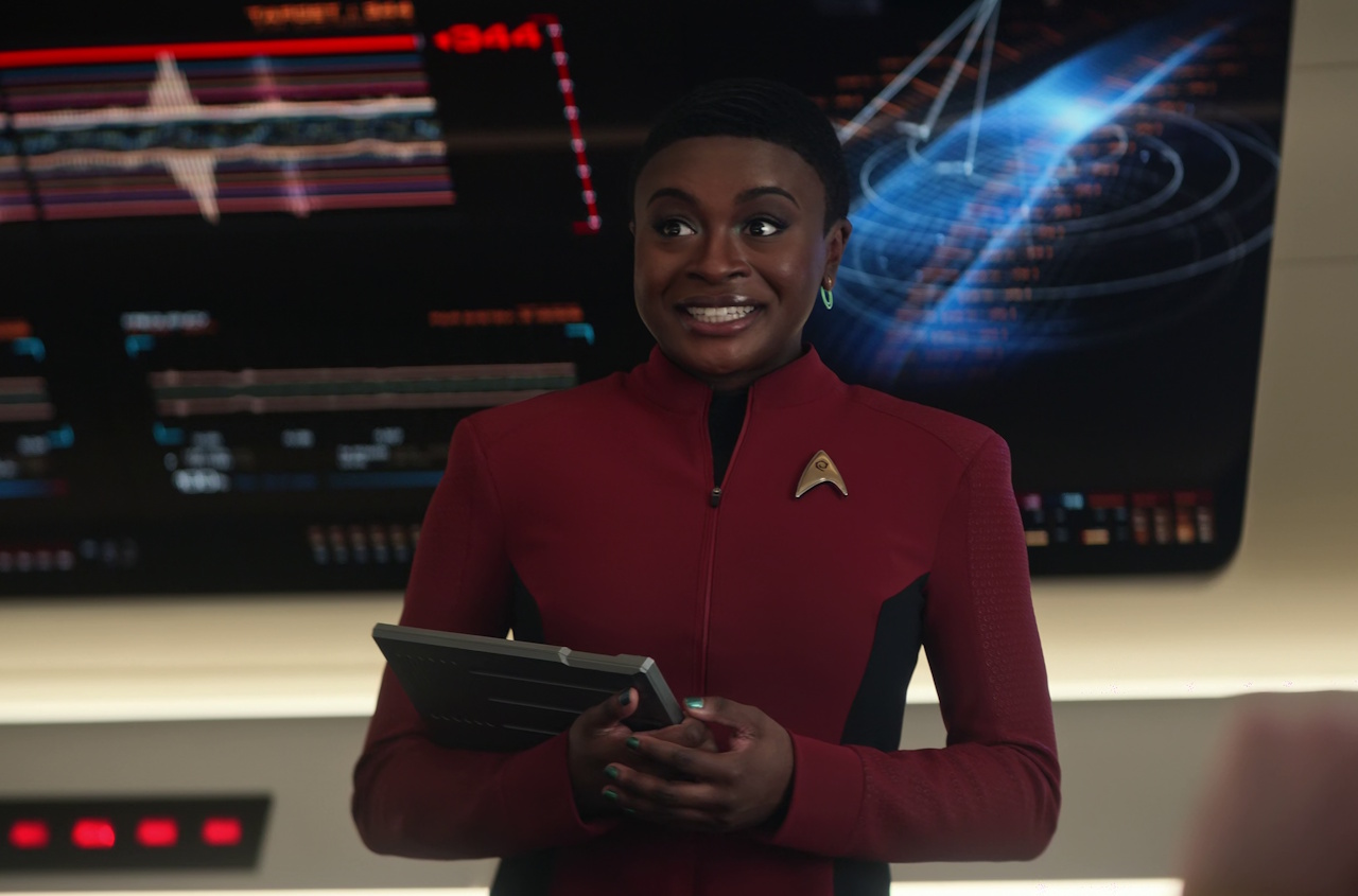 Still frame from Star Trek: Strange New Worlds Season 2 (2023) showing Uhura holding a padd.