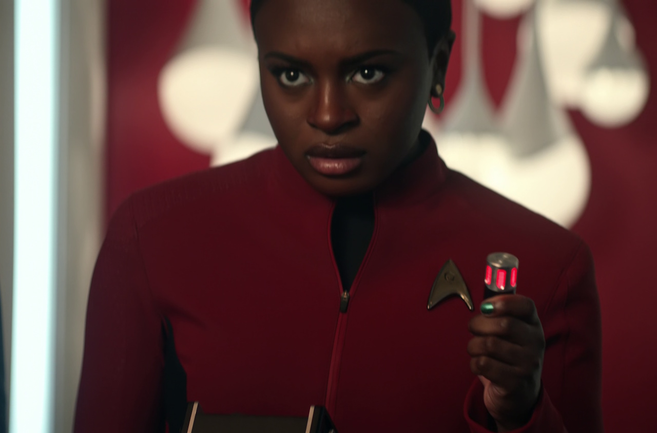 Still frame from Star Trek: Strange New Worlds Season 2 (2023) showing Uhura holding a tricorder.