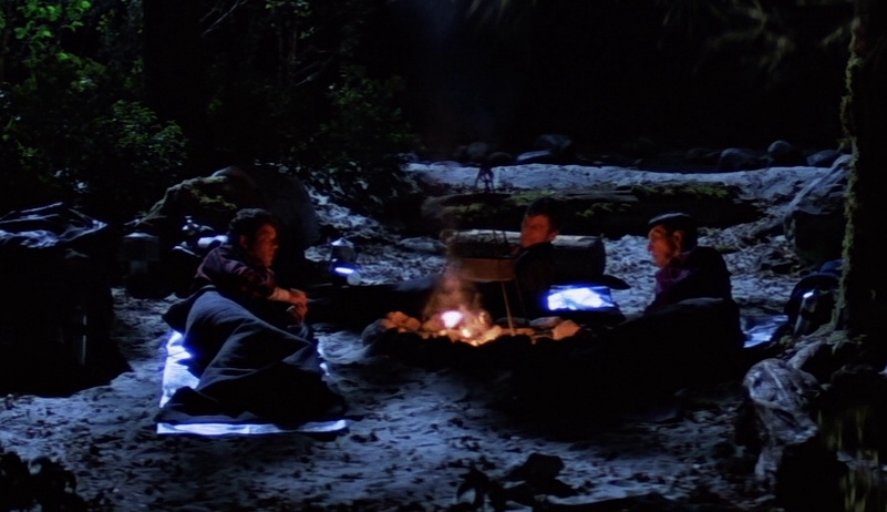 Still frame from Star Trek V: The Final Frontier showing Kirk, Spock, and Dr McCoy camping.