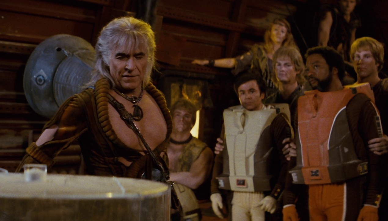 Still frame from Star Trek II: The Wrath of Khan showing Khan, Chekov, Captain Terrell, and several augments aboard the derelict Botany Bay.