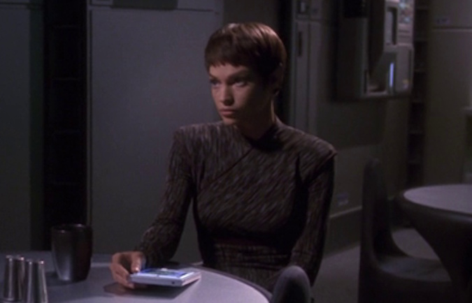 Still frame from Star Trek: Enterprise Season 2 showing T'Pol sat at a table.