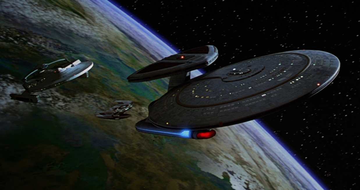 Still frame from Star Trek: Generations showing three starships departing Veridian III.